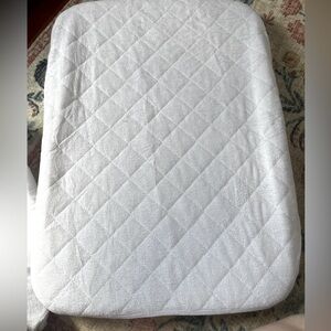Set of Nestig mini crib mattress protectors